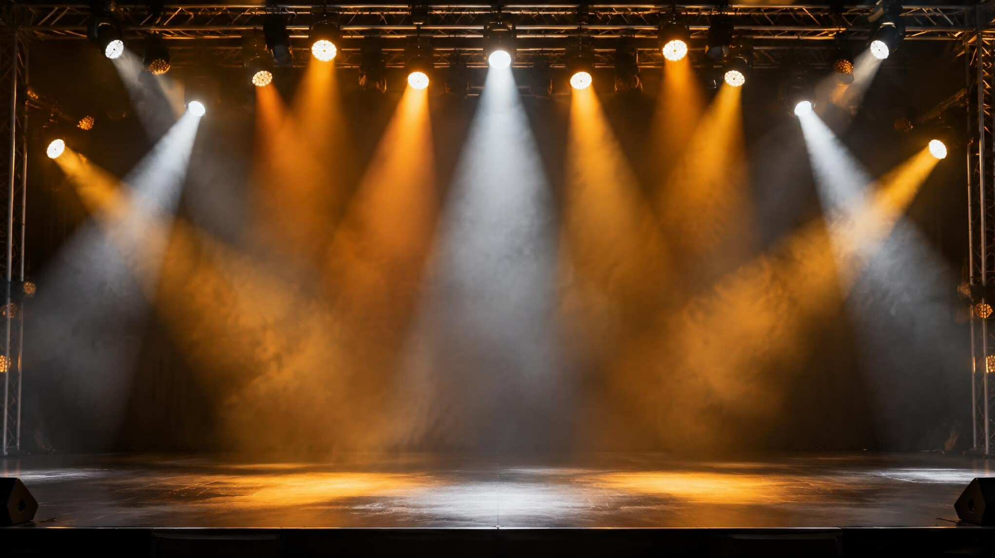 Stage lighting rig with warm spotlight beams